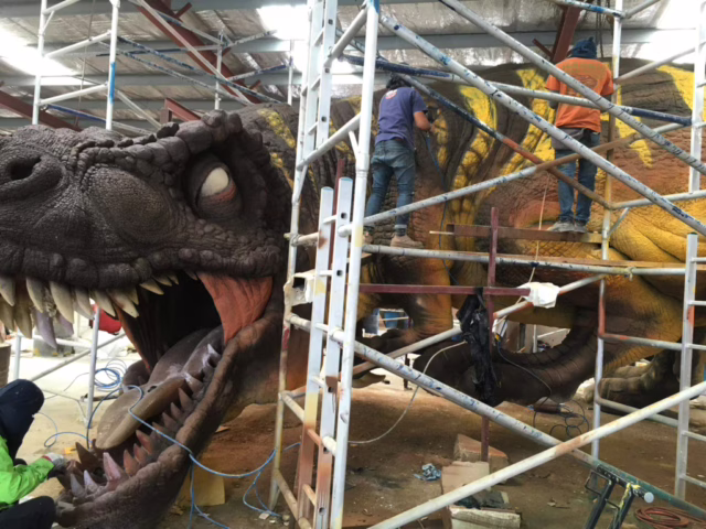 Our artists painting a dinosaur.